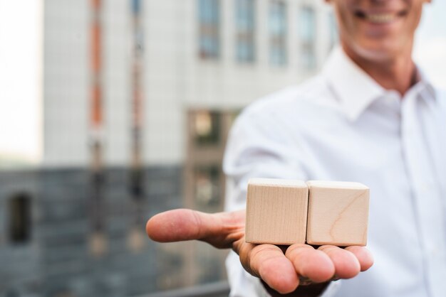 Businessman holding cubes in hand