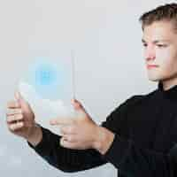 Free photo businessman holding a digital screen that generated globe