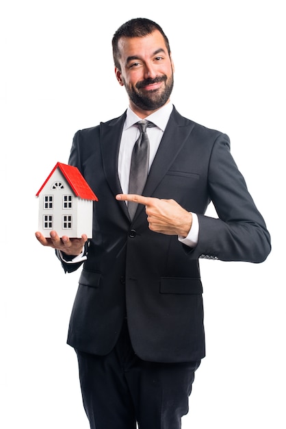 Free Photo businessman holding a little house