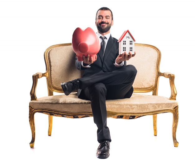 Free Photo businessman holding a piggybank