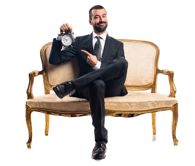 Businessman holding vintage clock