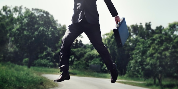 Businessman jump up in the park