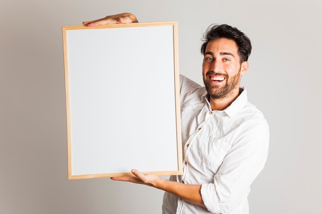 Businessman laughing and hlding whiteboard