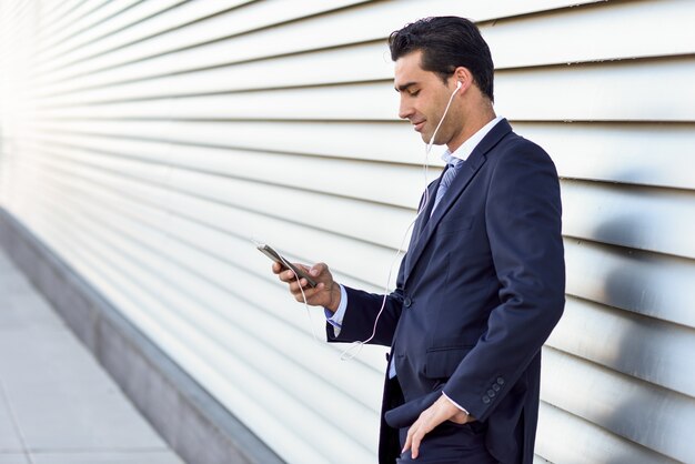  businessman listening to music on his mobile