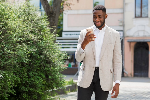 Businessman looking on smartphone