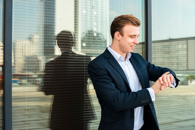 Businessman looking at wrist watch