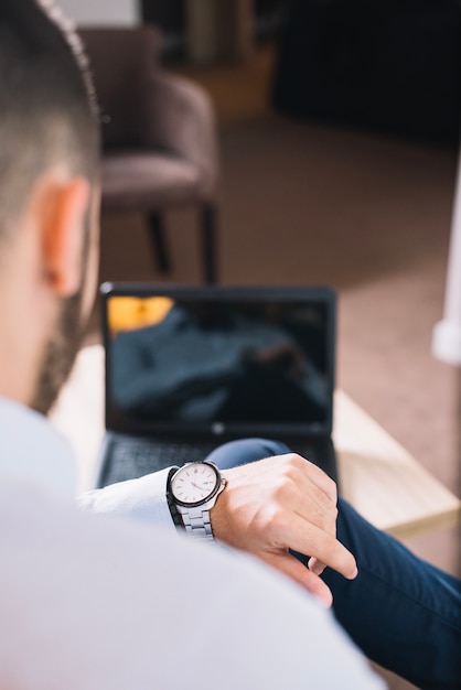 Businessman looking at wristwatch