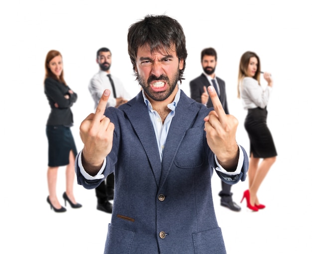 Businessman making horn gesture over white background