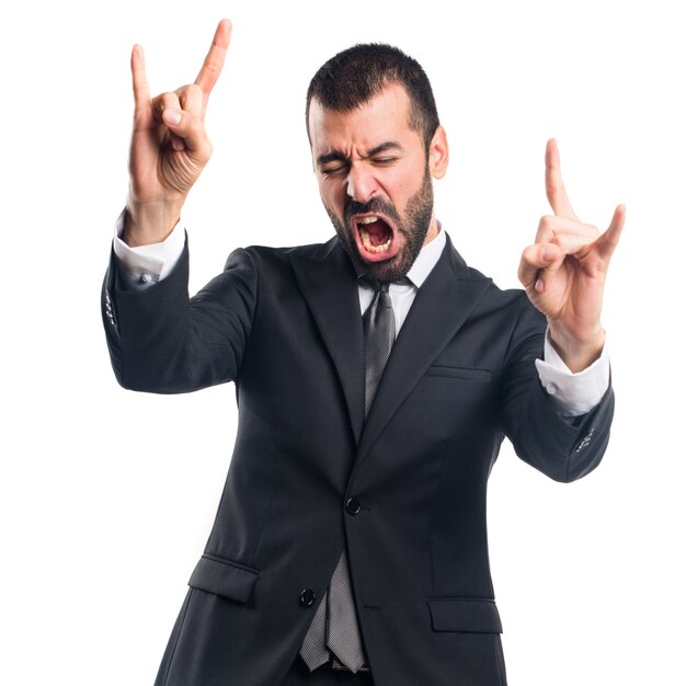 Businessman making horn gesture