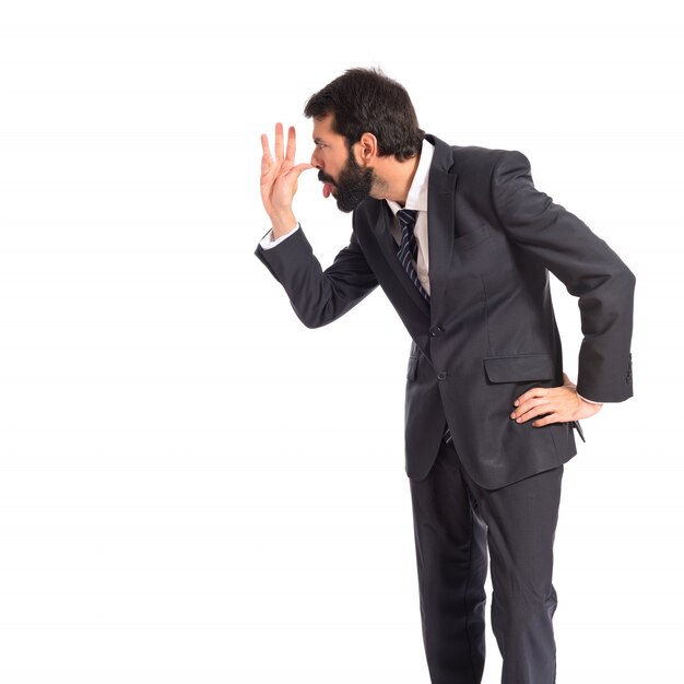 Businessman making a joke over white background