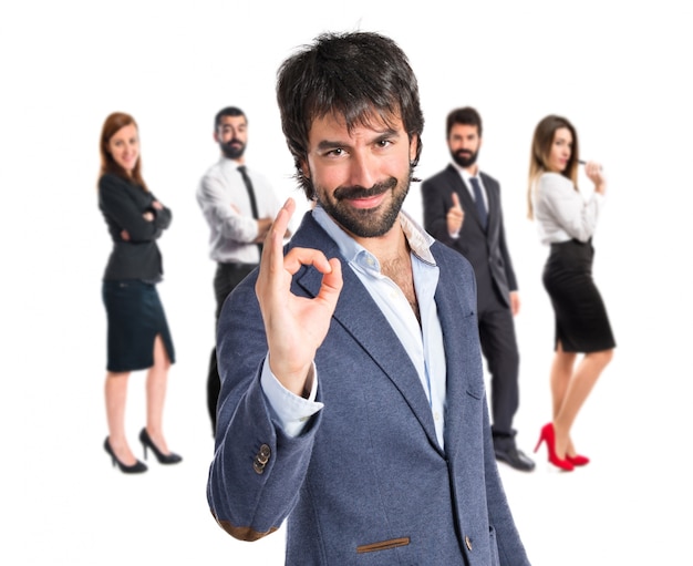 Businessman making Ok sign over white background