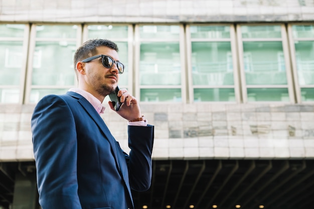 Businessman making phone call in urban environment