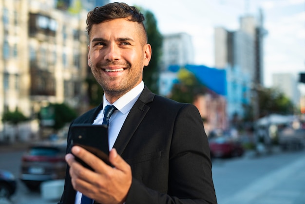 Businessman outdoors smiling and walking