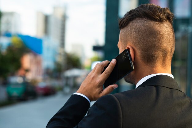 Businessman outdoors talking on the phone