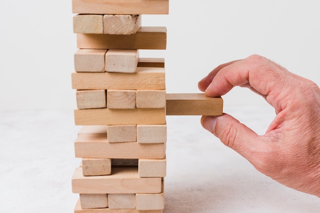 Free photo businessman playing jenga