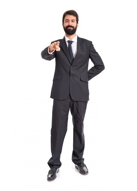 Businessman pointing to the front over white background