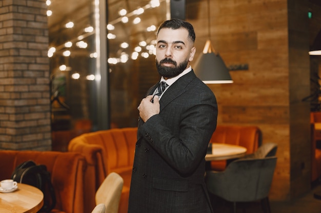 Businessman posing in a cafe