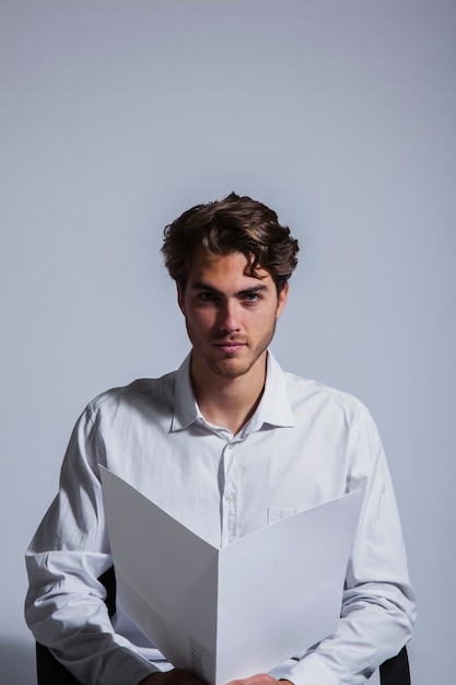 Free Photo businessman posing with folder