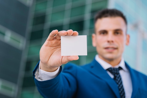 Free photo businessman presenting blank business card