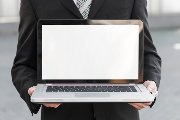 Free photo businessman presenting laptop screen