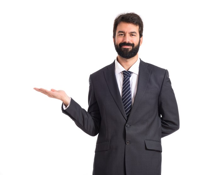 Businessman presenting something over isolated white background