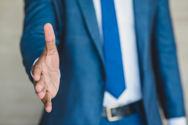 Free Photo businessman reaching out his hand