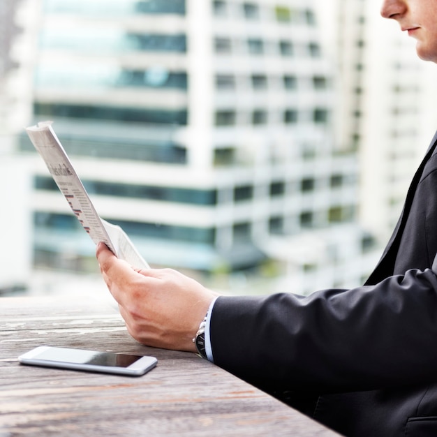 Free photo businessman reading the financial news