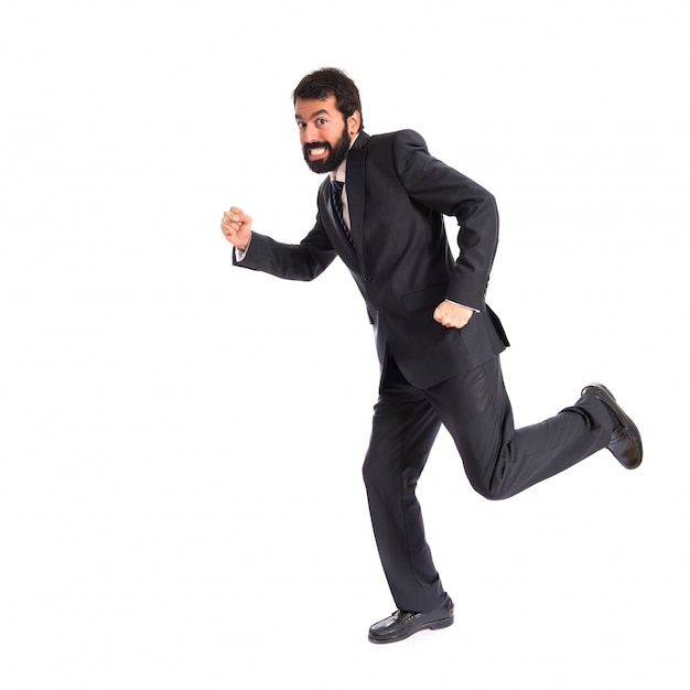 Businessman running fast over white background