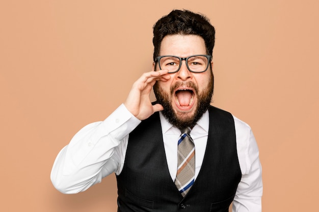 Businessman screaming on orange background