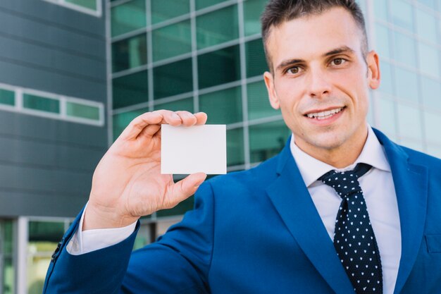 Businessman showing blank business card