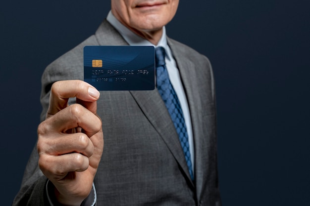 Free photo businessman showing a credit card