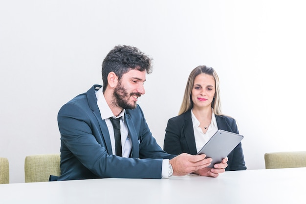 Businessman showing digital tablet to her colleague