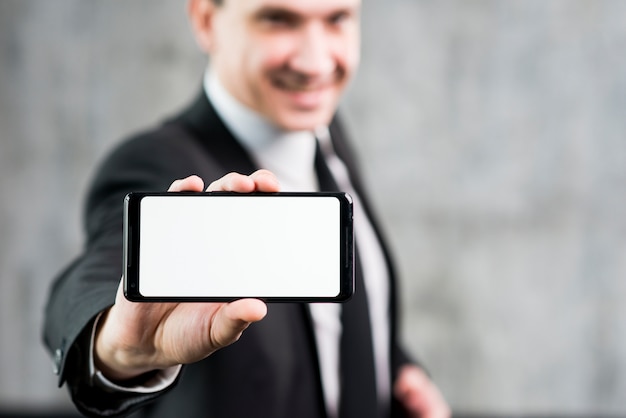 Free photo businessman showing smartphone with clear display