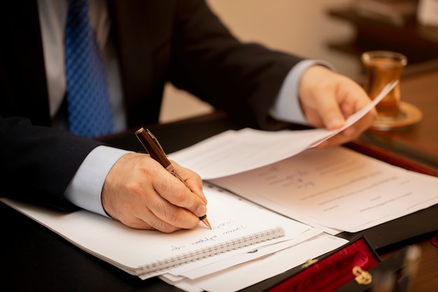 Free photo businessman signing important contract papers