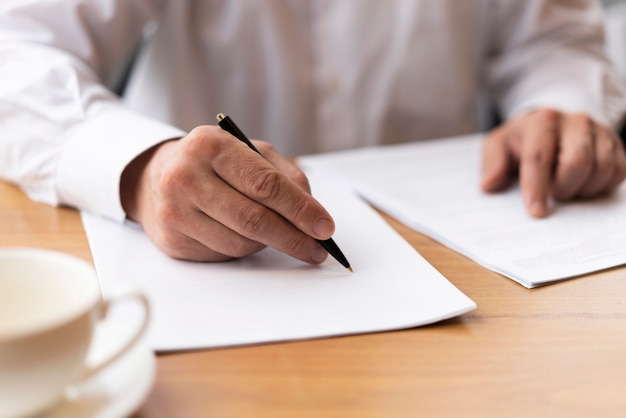 Free Photo businessman signing papers at the office