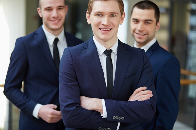 Businessman standing in front of his workmates