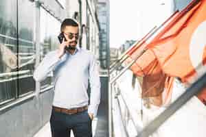 Free photo businessman talking phone at flags