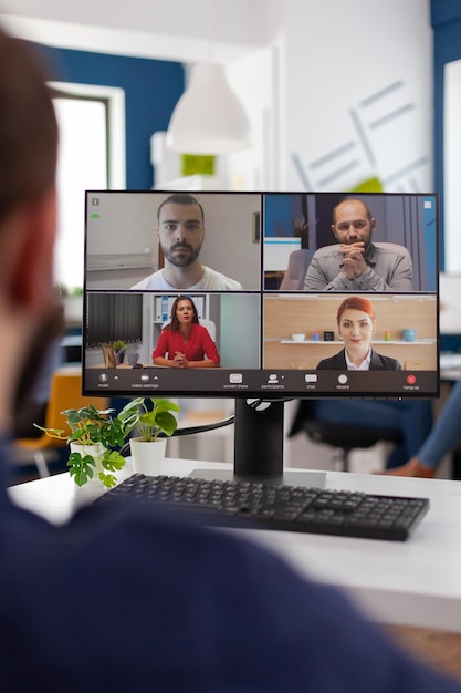 Free Photo businessman talking with remote team planning management strategy together during online videocall meeting conference in startup business company office. teleconference call on computer screen