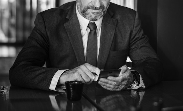 Free Photo businessman texting on his mobile phone