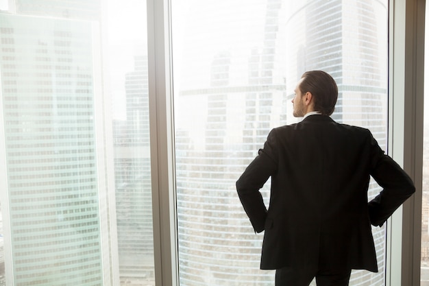 Businessman thinking about future near window