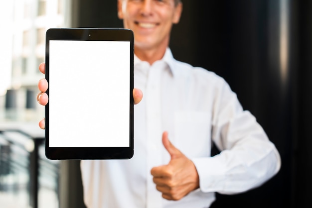 Businessman thumbs up holding tablet mock-up