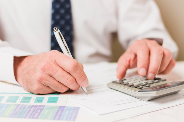 Businessman using calculator