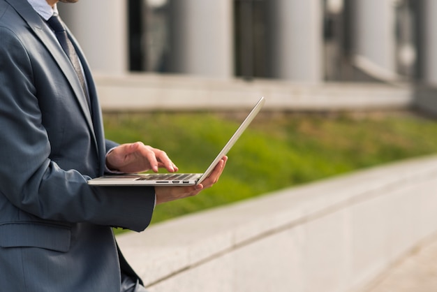 Businessman using laptop outdoors