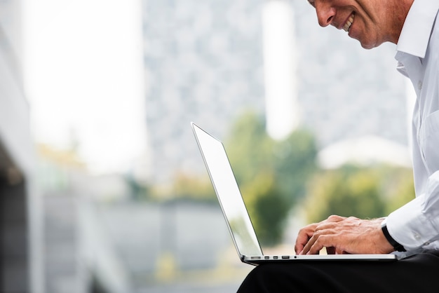 Free Photo businessman using laptop while sitting