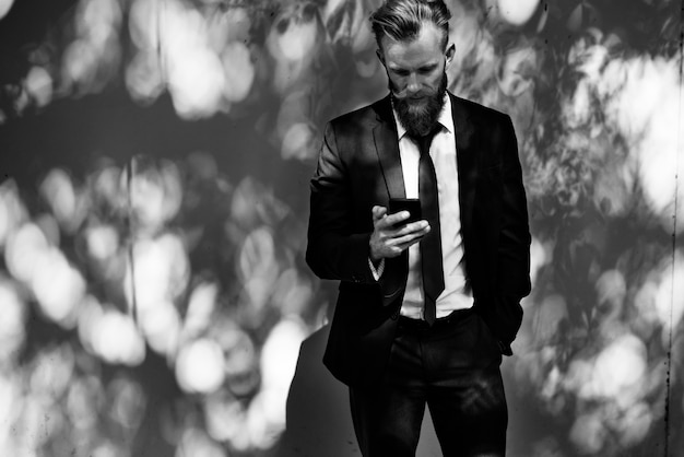 Free photo businessman using mobile phone communication technology