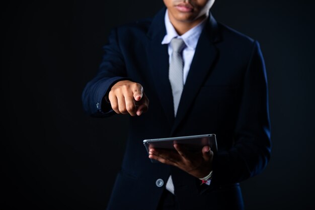 Businessman using tablet analyzing sales data and economic growth graph chart, Technology