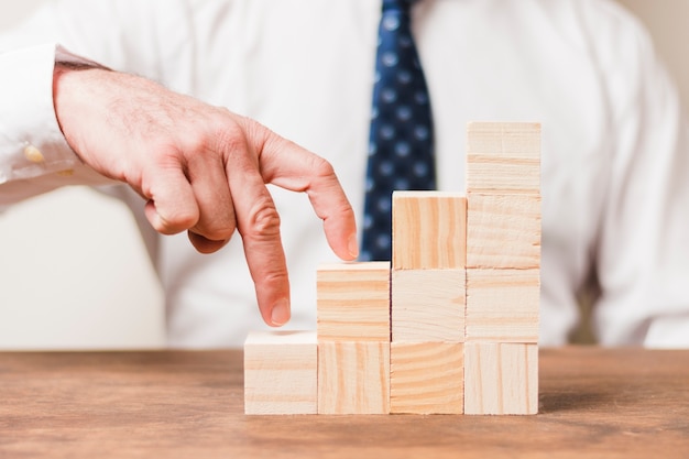 Businessman using wooden pieces 