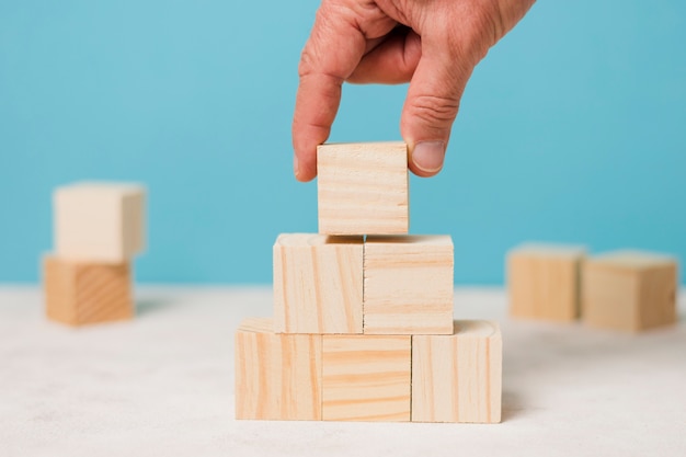 Businessman using wooden pieces 