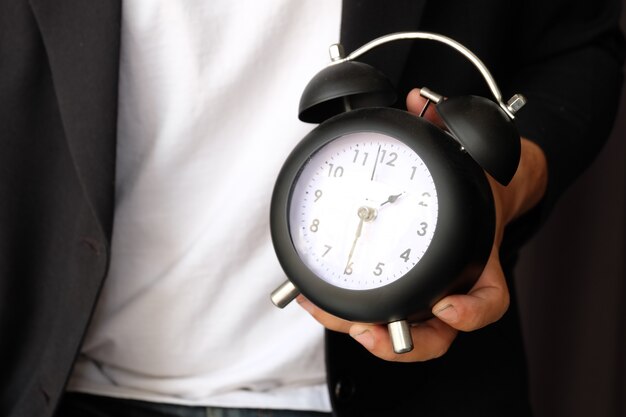 Free photo businessman with business concept , holding clock