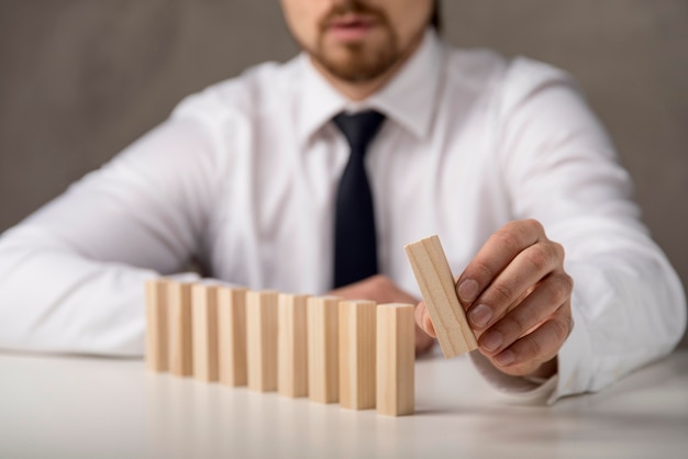 Businessman with domino pieces